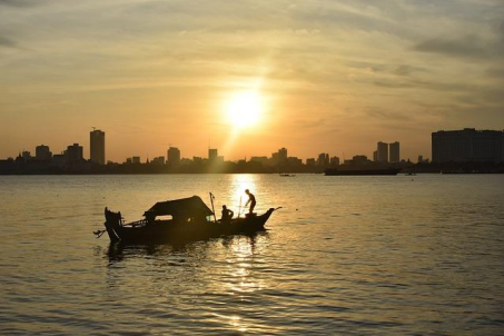 men-on-boat-at-sunset