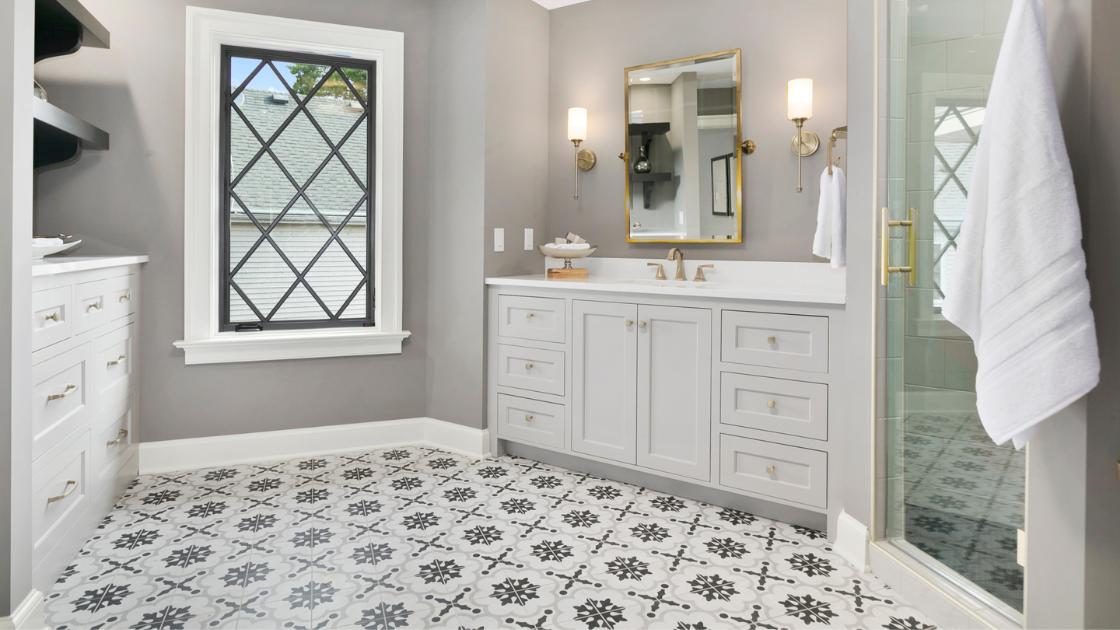 A bathroom with geometric shapes on the tiles. 