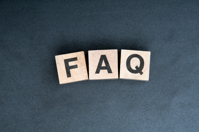 Drei Holzwürfel mit Buchstaben, die das Wort FAQ bilden