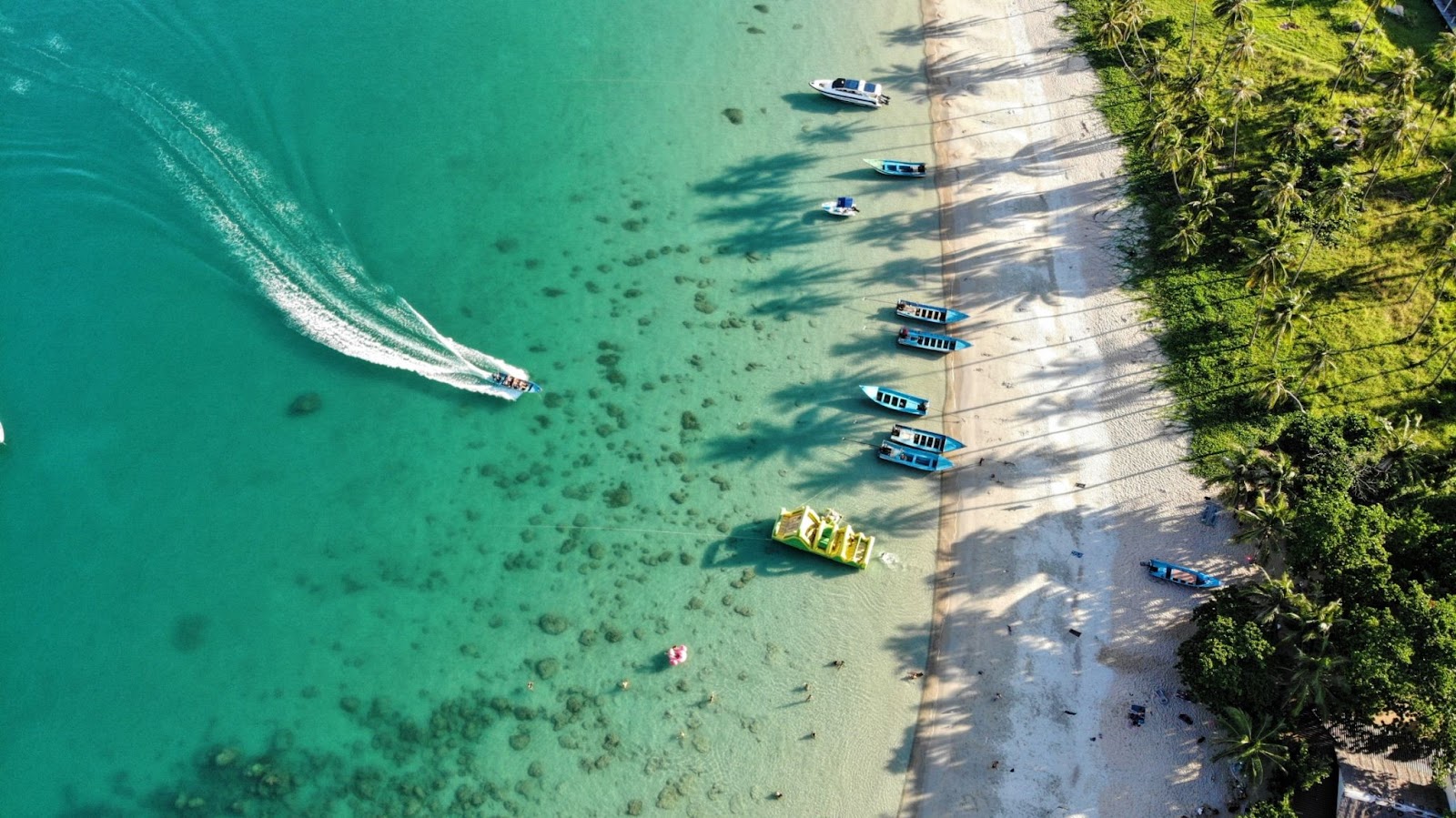 aerial view of boat coming into island